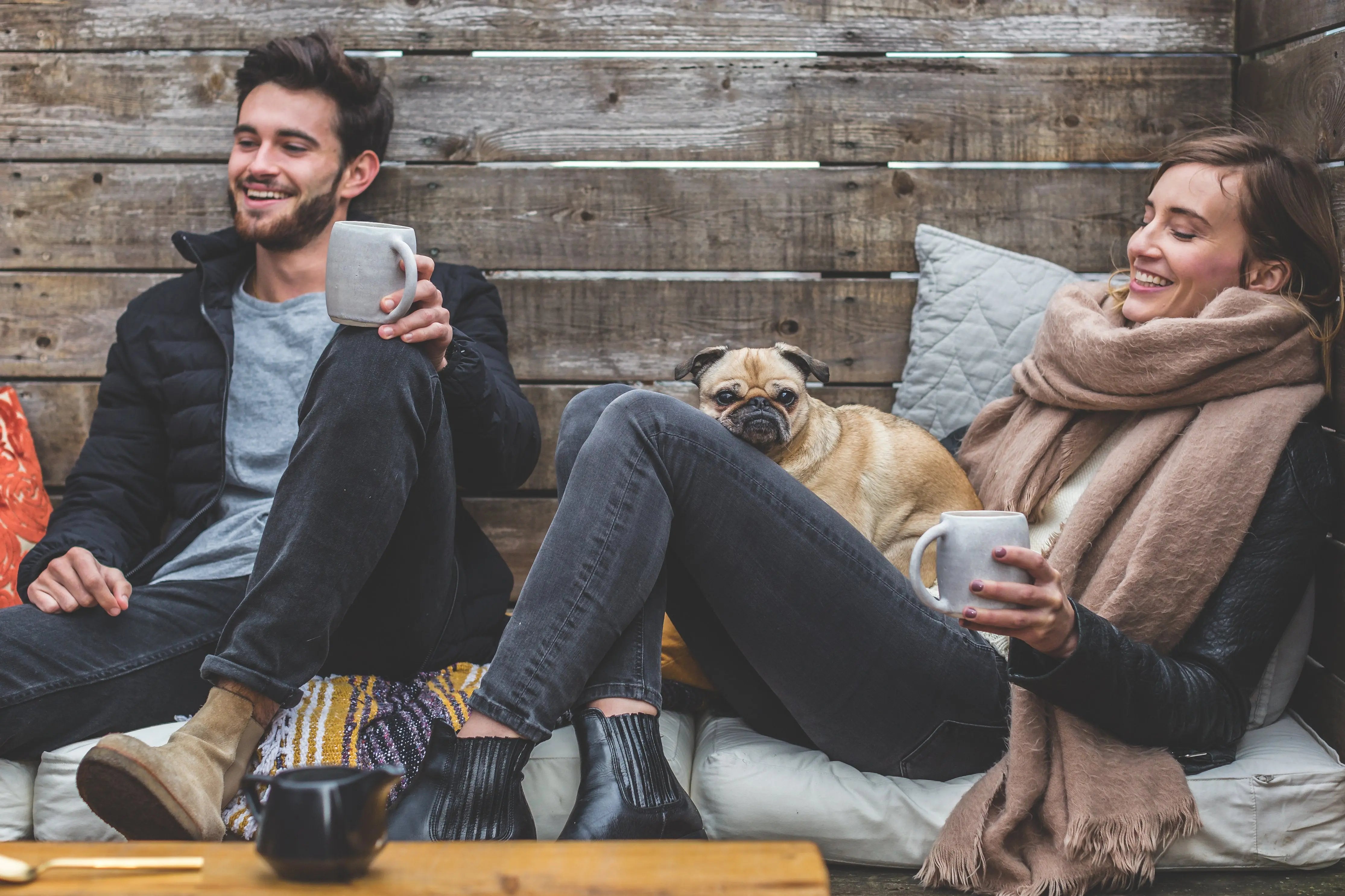 Is Coffee Ruining Your Teeth? Two people drinking coffee with a dog.