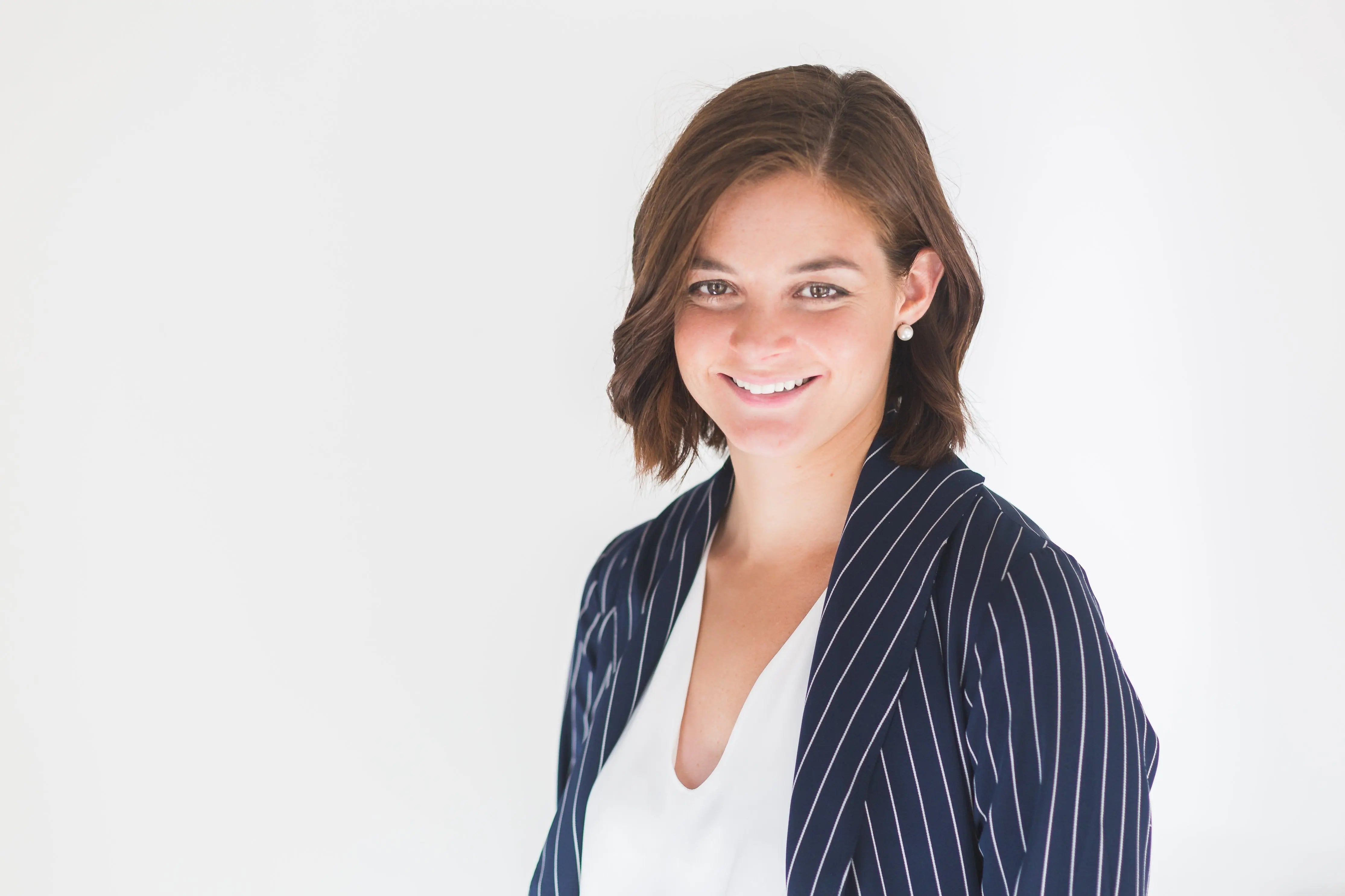Woman with bright smile, blue jacket | Healthy gums