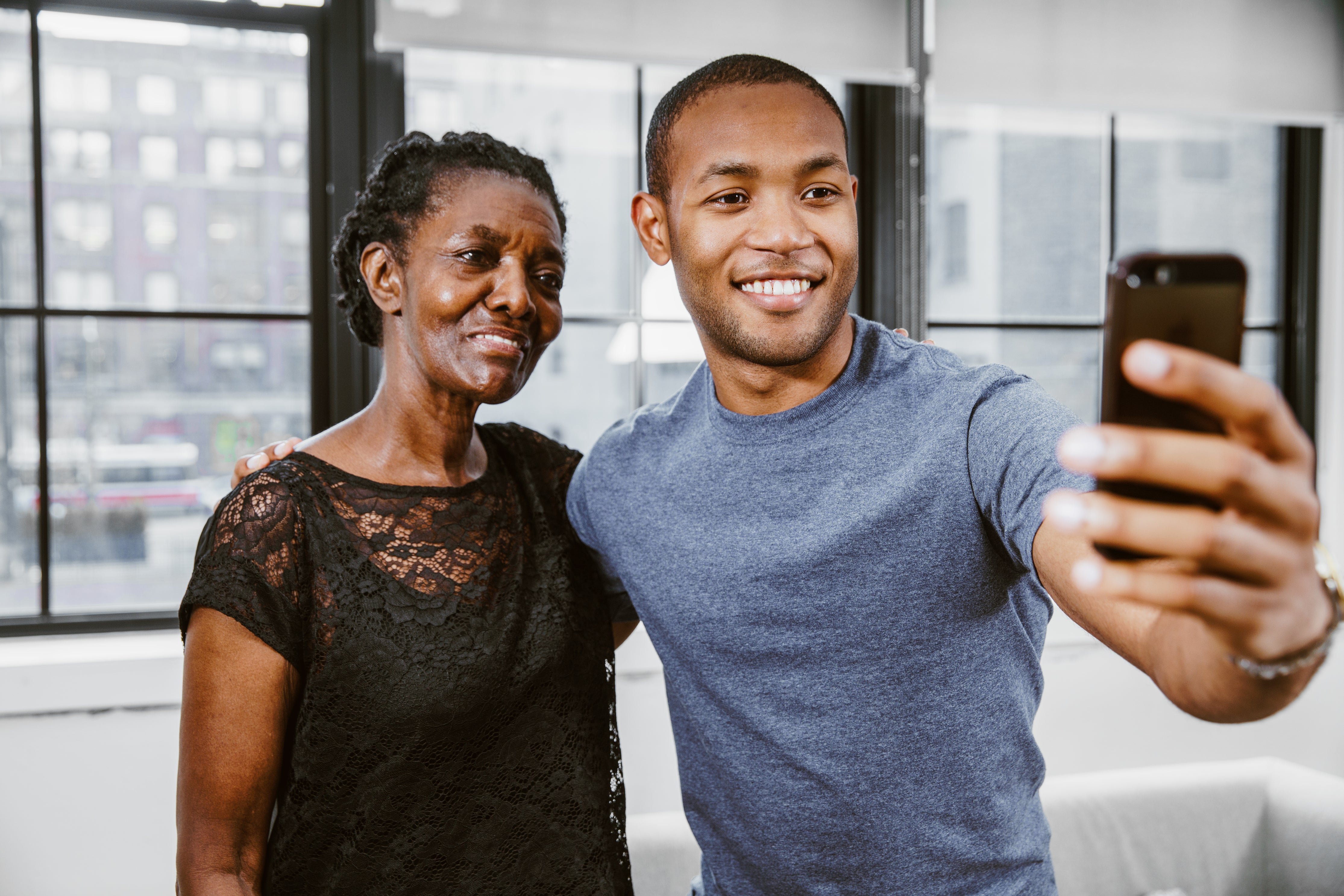 son and mom smiling with white teeth taking a selfie