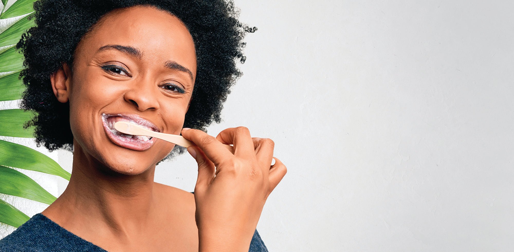Heal early stage cavities by allowing your teeth to remineralize with natural hydroxyapatite effectively targeting early cavities while whitening your smile. Woman brushing teeth.